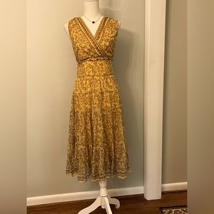 Gorgeous gold and red chiffon lined printed v-neck ruffled dress!